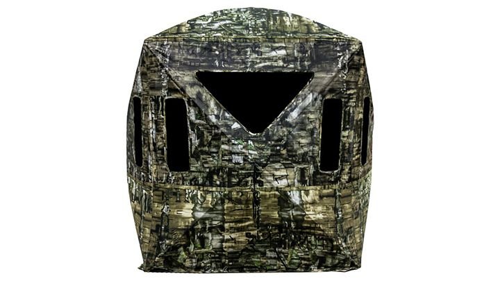 Hunter setting up portable ground blind for early season bowhunting