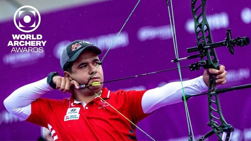Target archer holding compound bow at full draw weight