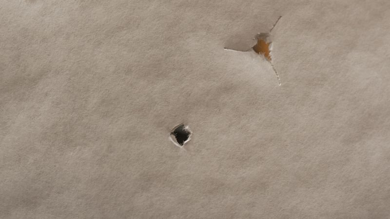 compound bow paper tuning showing bullet hole versus tear pattern comparison