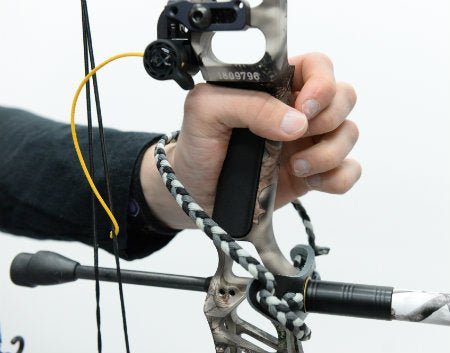 archery wrist sling attached to compound bow riser